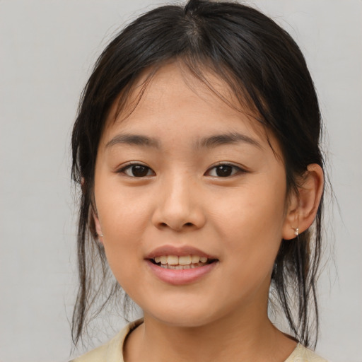 Joyful asian young-adult female with medium  brown hair and brown eyes