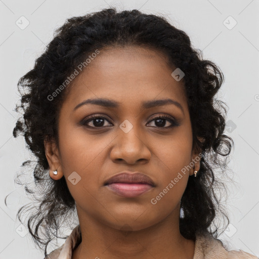 Joyful black young-adult female with long  brown hair and brown eyes