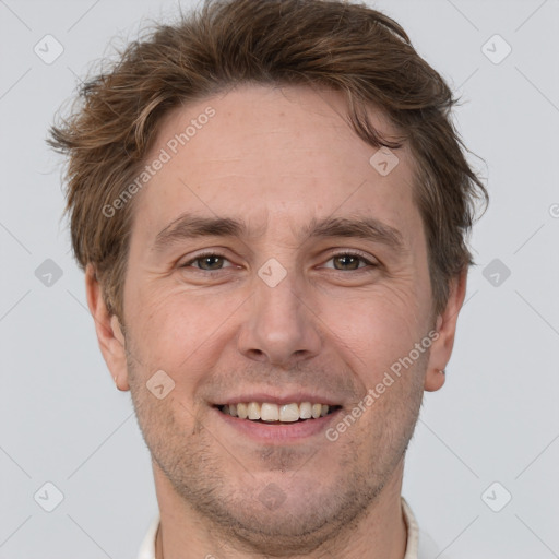 Joyful white adult male with short  brown hair and grey eyes