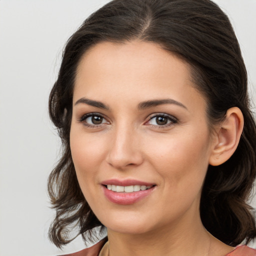 Joyful white young-adult female with medium  brown hair and brown eyes