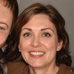 Joyful white adult female with medium  brown hair and brown eyes