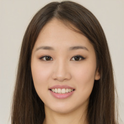 Joyful asian young-adult female with long  brown hair and brown eyes