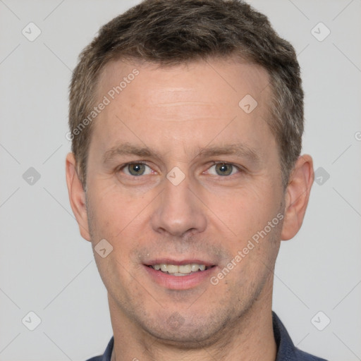 Joyful white adult male with short  brown hair and brown eyes