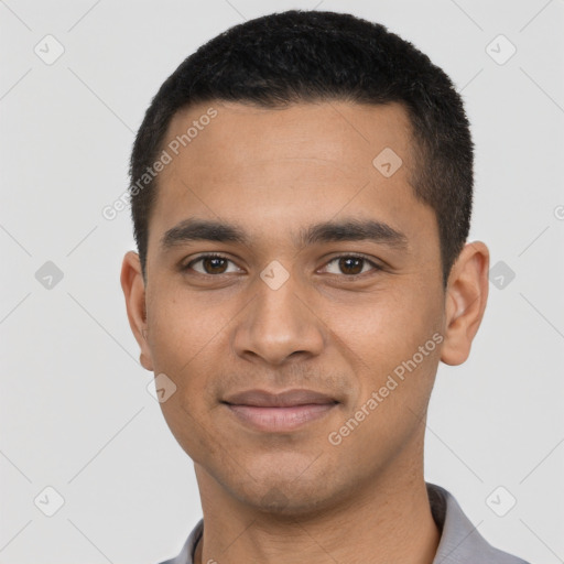 Joyful latino young-adult male with short  black hair and brown eyes