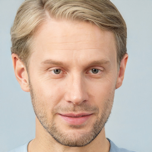 Joyful white adult male with short  brown hair and grey eyes