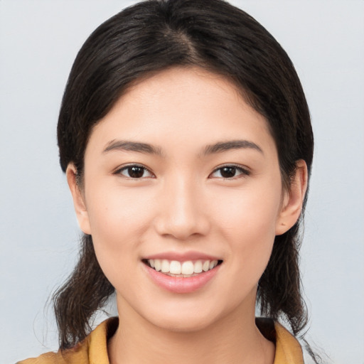 Joyful asian young-adult female with medium  brown hair and brown eyes