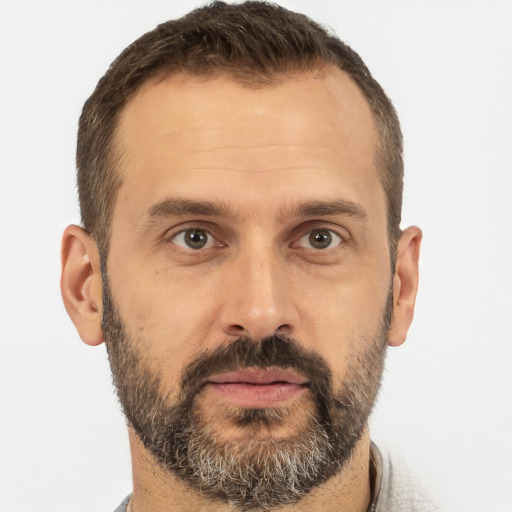 Joyful white adult male with short  brown hair and brown eyes