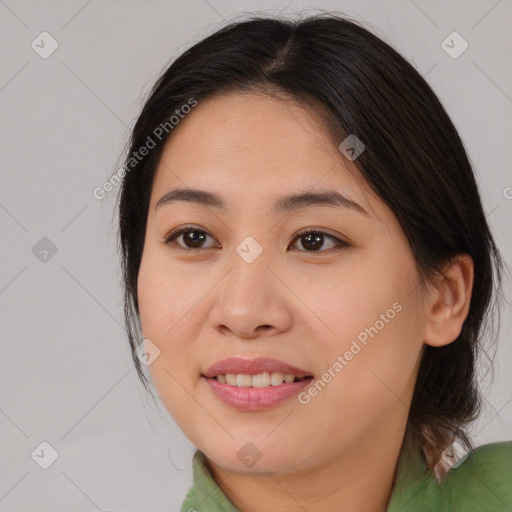 Joyful asian young-adult female with medium  brown hair and brown eyes