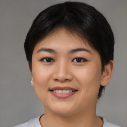 Joyful asian young-adult female with short  brown hair and brown eyes