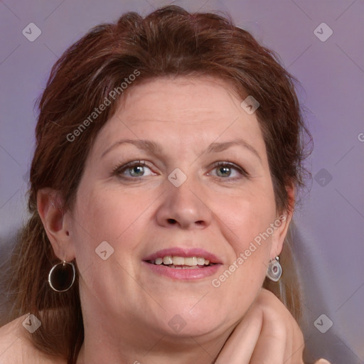 Joyful white adult female with medium  brown hair and blue eyes