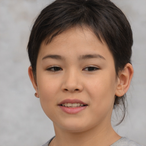 Joyful white child female with short  brown hair and brown eyes