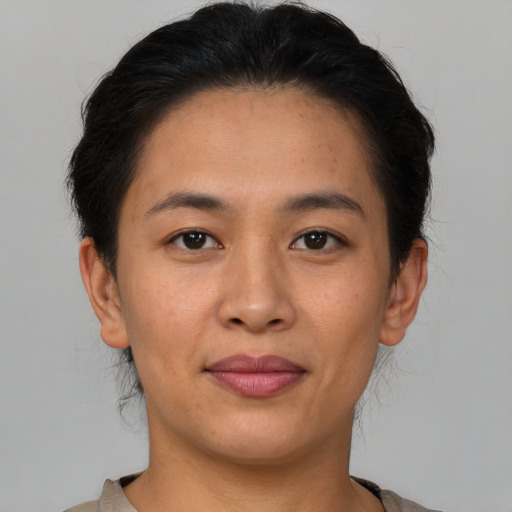 Joyful asian young-adult female with short  brown hair and brown eyes