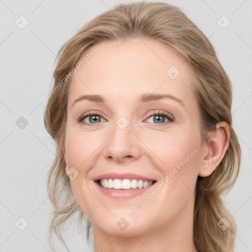 Joyful white young-adult female with medium  brown hair and blue eyes