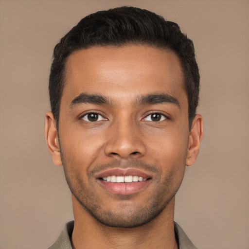 Joyful latino young-adult male with short  brown hair and brown eyes