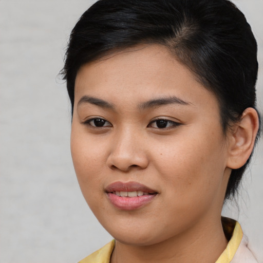 Joyful asian young-adult female with medium  brown hair and brown eyes