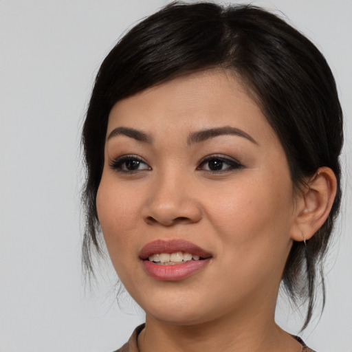 Joyful asian young-adult female with medium  black hair and brown eyes