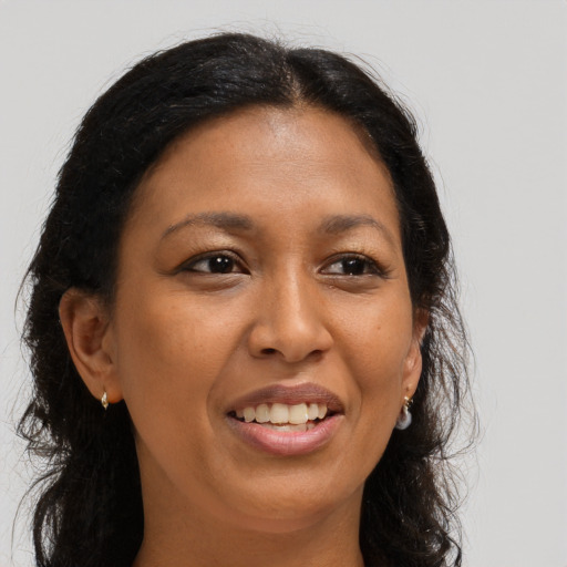 Joyful black young-adult female with long  brown hair and brown eyes