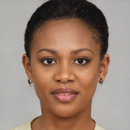 Joyful black young-adult female with short  brown hair and brown eyes