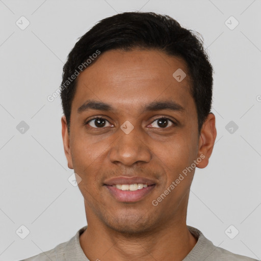 Joyful black young-adult male with short  black hair and brown eyes