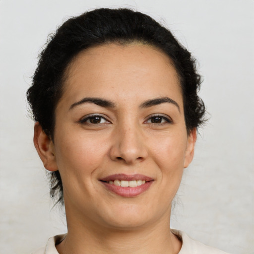 Joyful latino young-adult female with short  brown hair and brown eyes