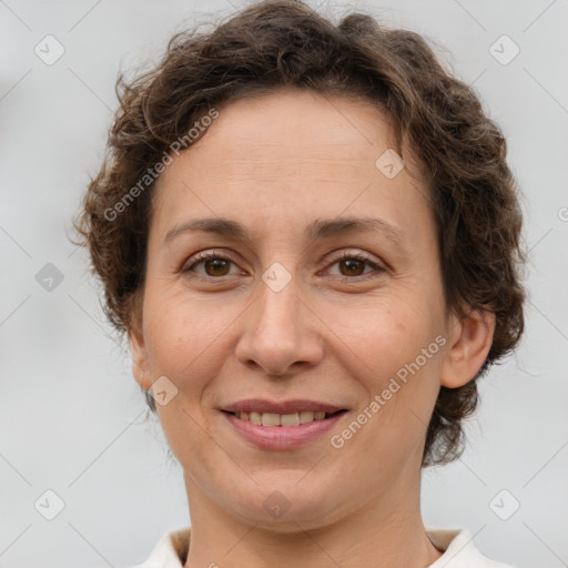 Joyful white adult female with short  brown hair and brown eyes