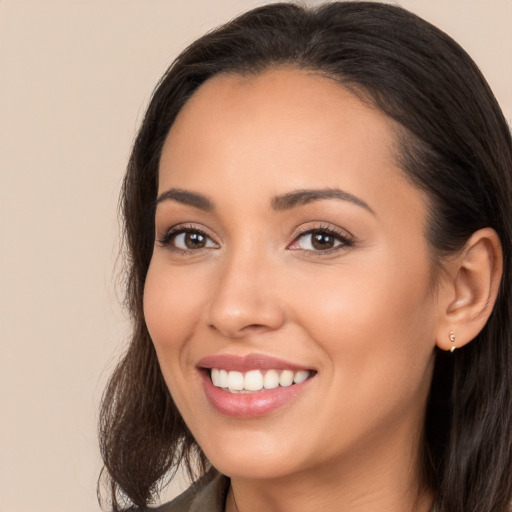 Joyful white young-adult female with long  brown hair and brown eyes