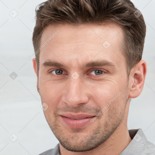 Joyful white adult male with short  brown hair and grey eyes