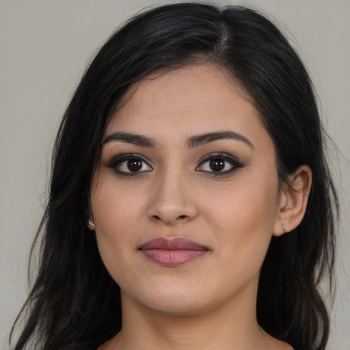 Joyful latino young-adult female with long  brown hair and brown eyes