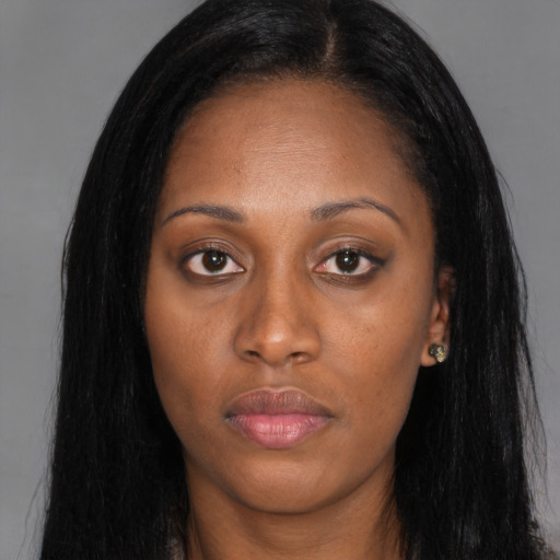 Joyful black young-adult female with long  black hair and brown eyes