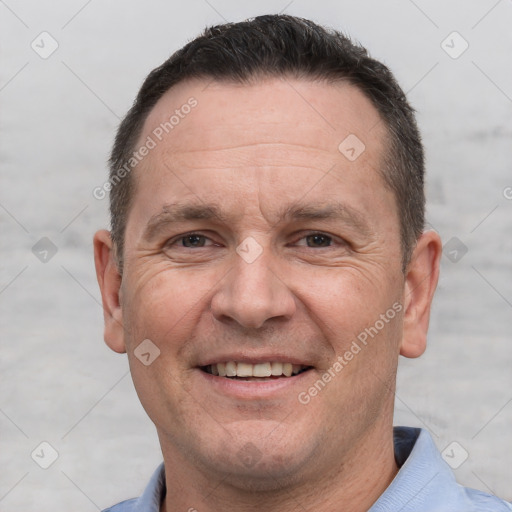 Joyful white adult male with short  brown hair and brown eyes