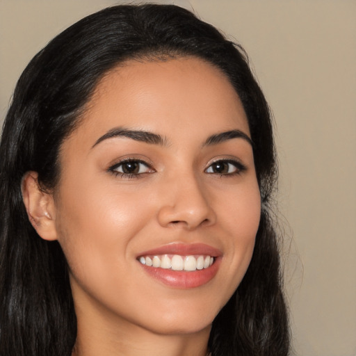 Joyful latino young-adult female with long  brown hair and brown eyes