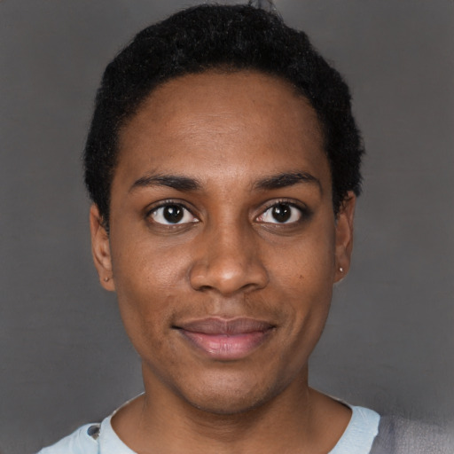 Joyful black young-adult female with short  black hair and brown eyes