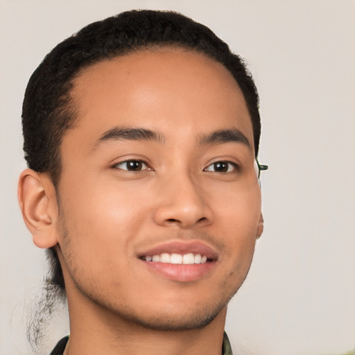 Joyful latino young-adult male with short  brown hair and brown eyes