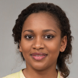 Joyful black young-adult female with medium  brown hair and brown eyes