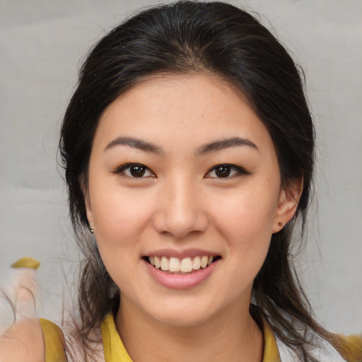Joyful asian young-adult female with medium  brown hair and brown eyes