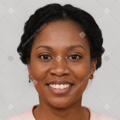 Joyful black young-adult female with short  black hair and brown eyes