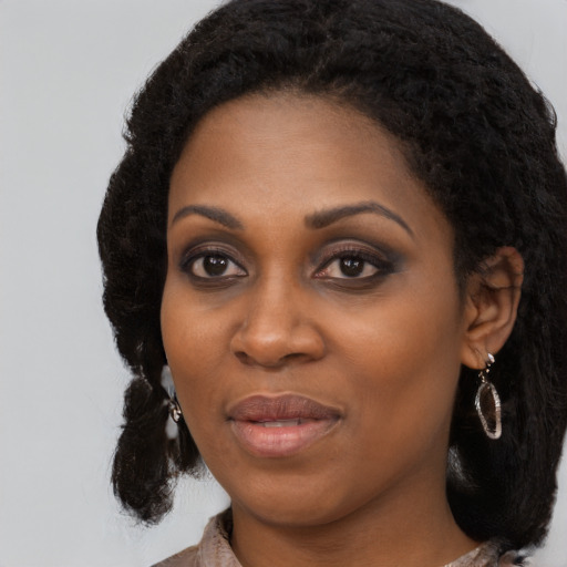 Joyful black young-adult female with medium  black hair and brown eyes