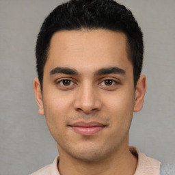 Joyful white young-adult male with short  black hair and brown eyes