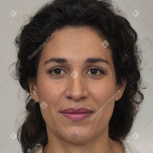 Joyful latino adult female with medium  brown hair and brown eyes