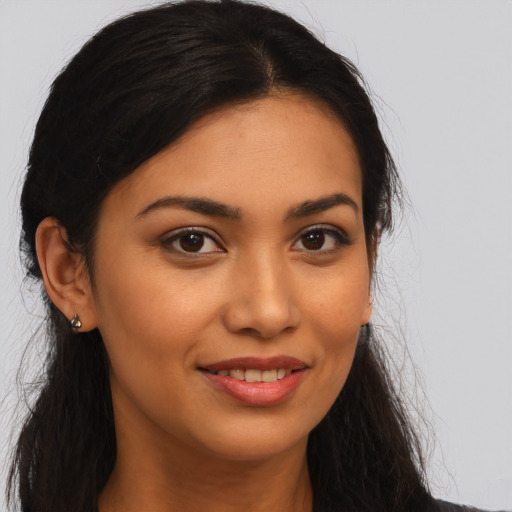 Joyful latino young-adult female with long  brown hair and brown eyes