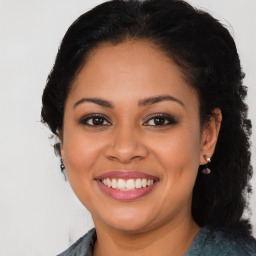 Joyful latino young-adult female with long  brown hair and brown eyes