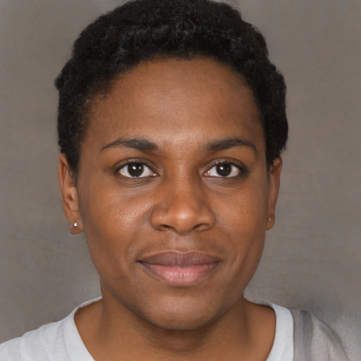 Joyful black young-adult female with short  black hair and brown eyes
