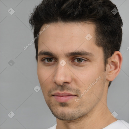 Joyful white young-adult male with short  black hair and brown eyes