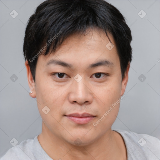 Joyful asian young-adult male with short  black hair and brown eyes