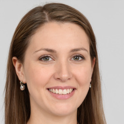 Joyful white young-adult female with long  brown hair and grey eyes