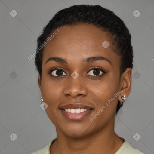 Joyful black young-adult female with short  black hair and brown eyes