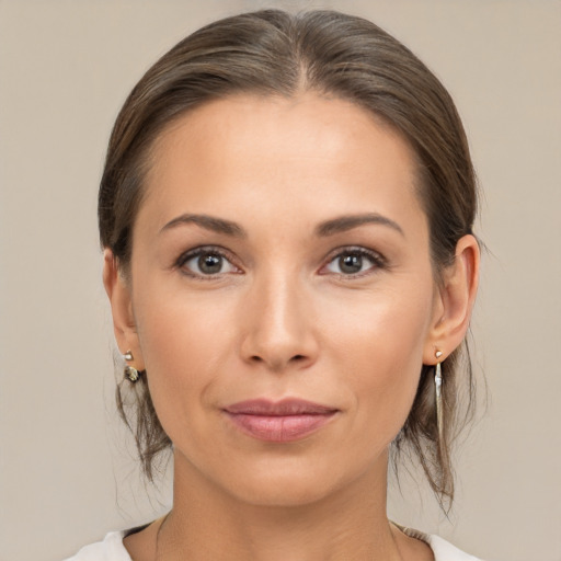 Joyful white young-adult female with medium  brown hair and brown eyes