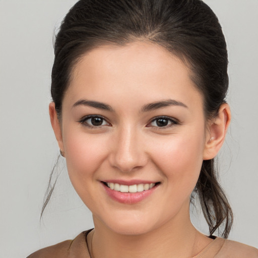 Joyful white young-adult female with medium  brown hair and brown eyes