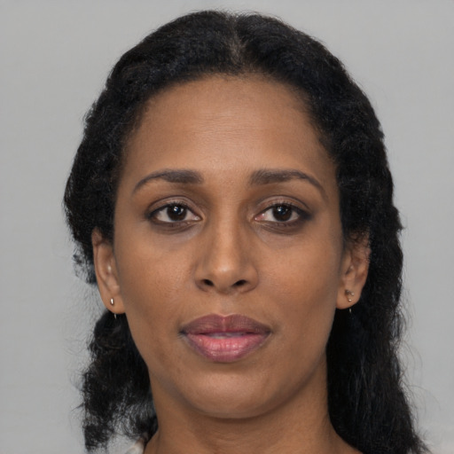 Neutral black adult female with medium  brown hair and brown eyes