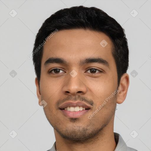 Joyful latino young-adult male with short  black hair and brown eyes